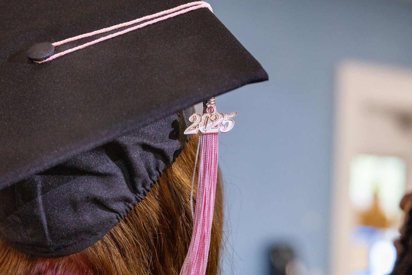 Graduate wearing a cap with a pink tassel